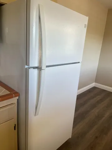 a view of a room with wooden floor
