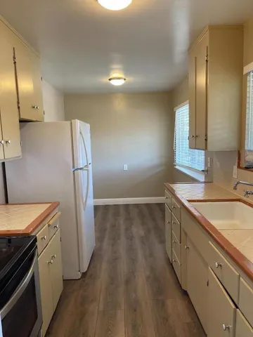 a kitchen with stainless steel appliances granite countertop a refrigerator and a sink