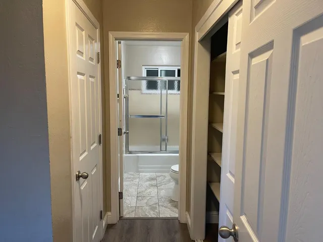 a view of a bathroom from a hallway