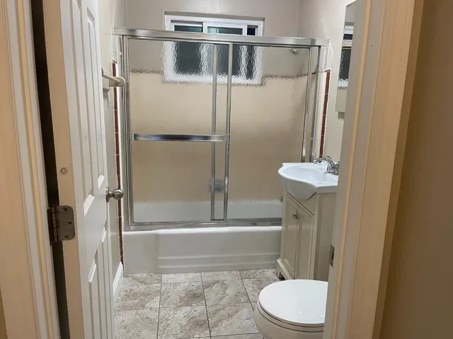 a bathroom with a toilet and a shower
