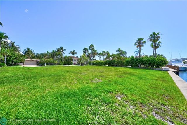 a view of a big yard with swimming pool and garden