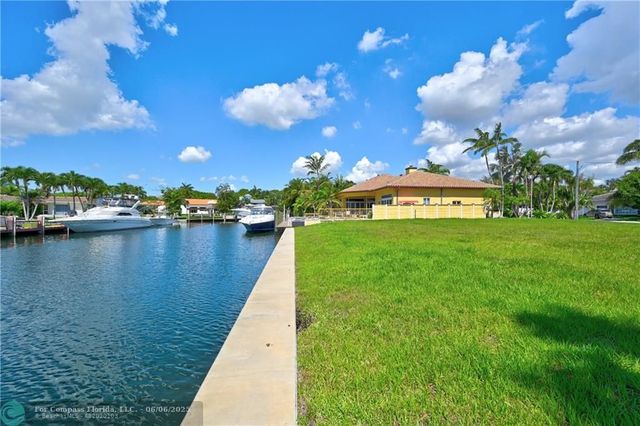 a view of a lake with boats and trees in the background