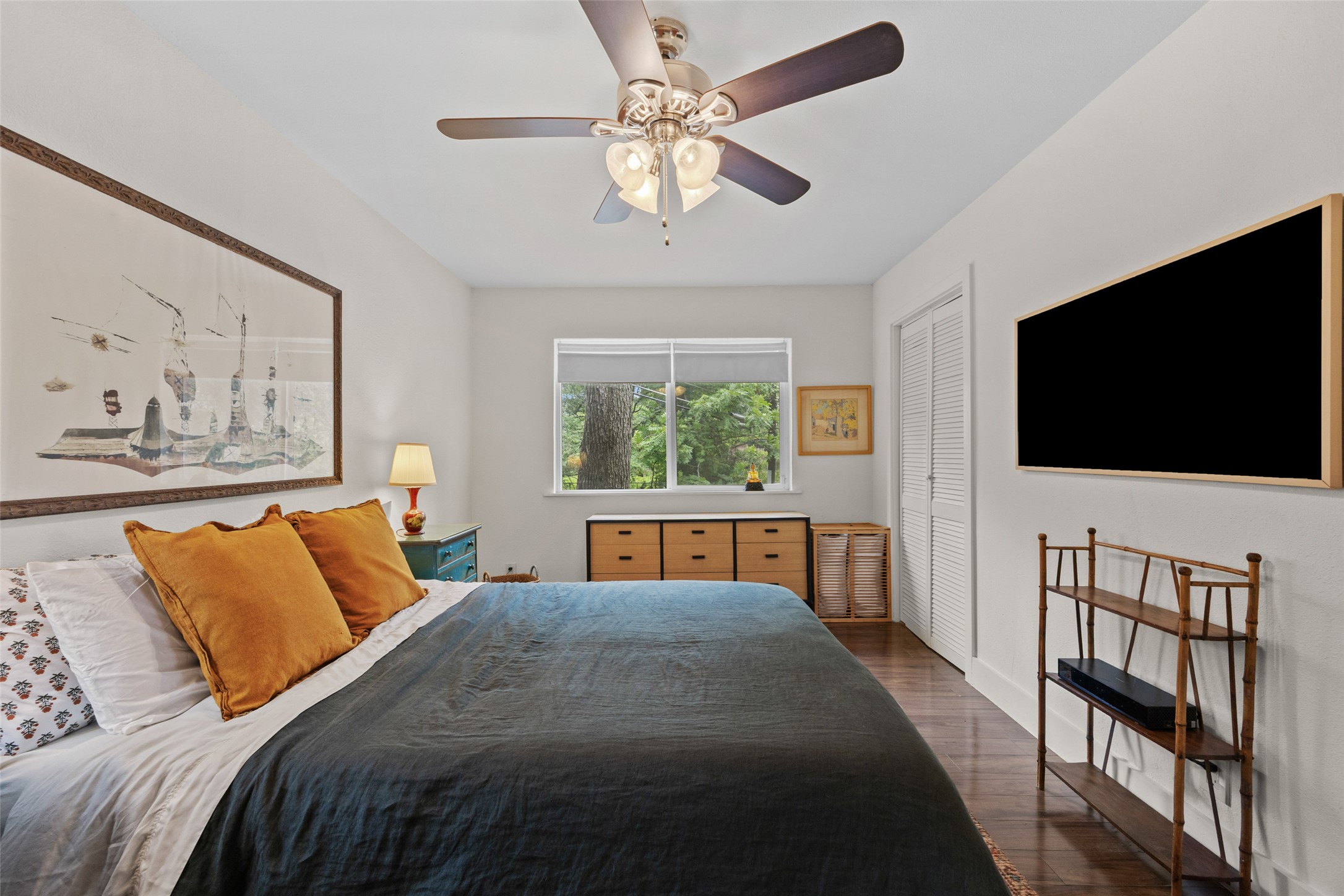 3302 Cherrywood Road Austin, TX 78722 - Photo 15 of 26 Hardwood floors and a tranquil window view elevate this cozy, private bedroom retreat.