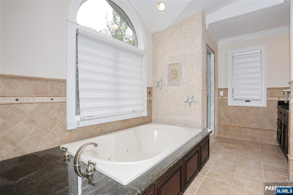 65 Ross Avenue Demarest, NJ 07627 - Photo 25 of 48 a bathroom with a tub and a shower