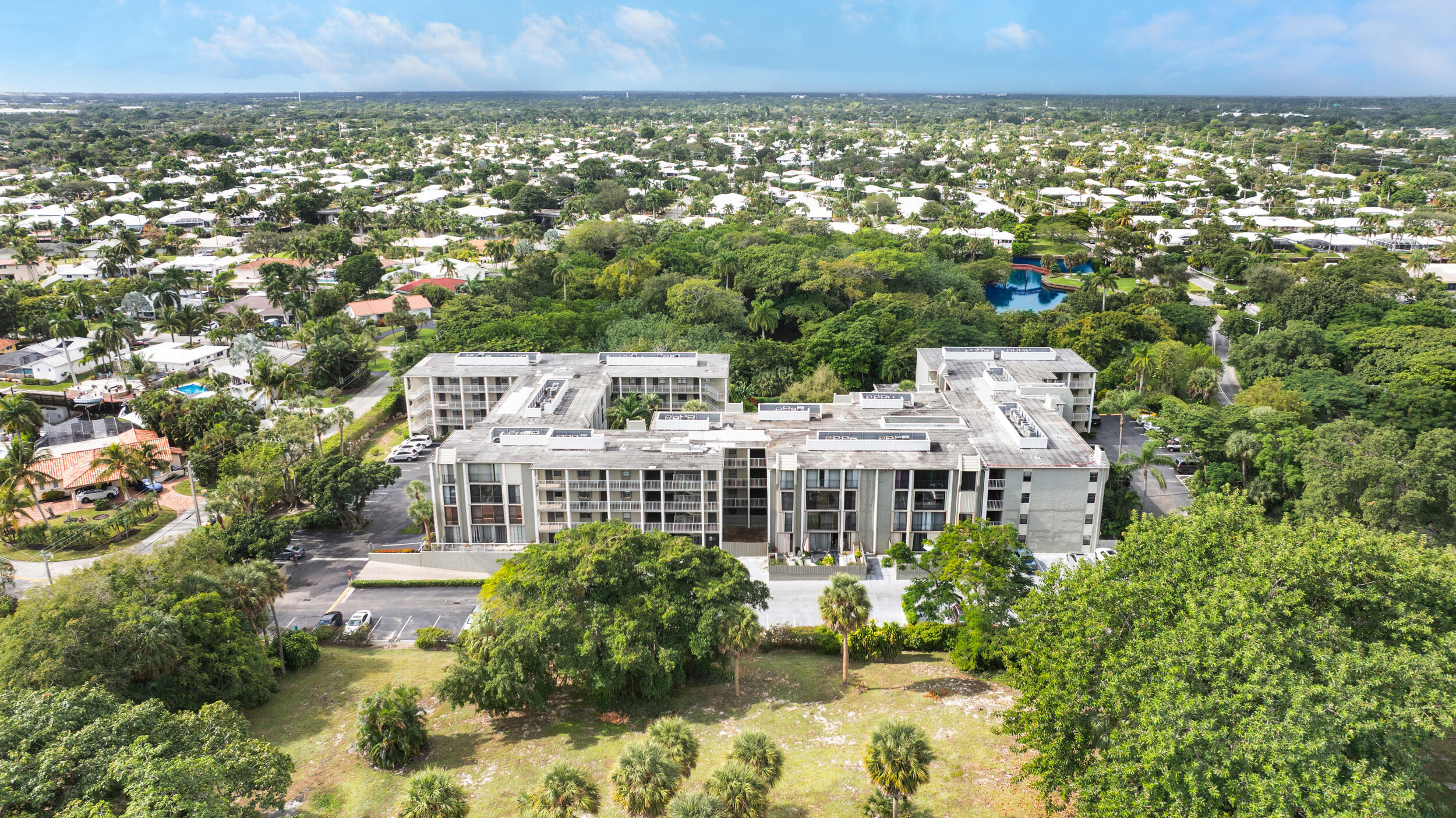 501 Southwest 11th Place, Unit 317 Boca Raton, FL 33432 - Photo 27 of 28 a view of a large building with a yard