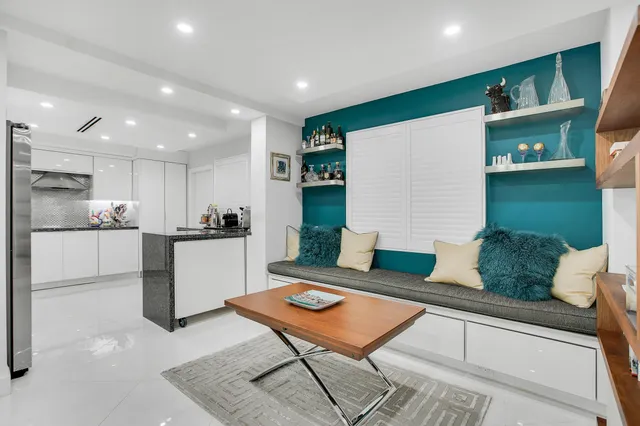a living room with kitchen island furniture and a kitchen view