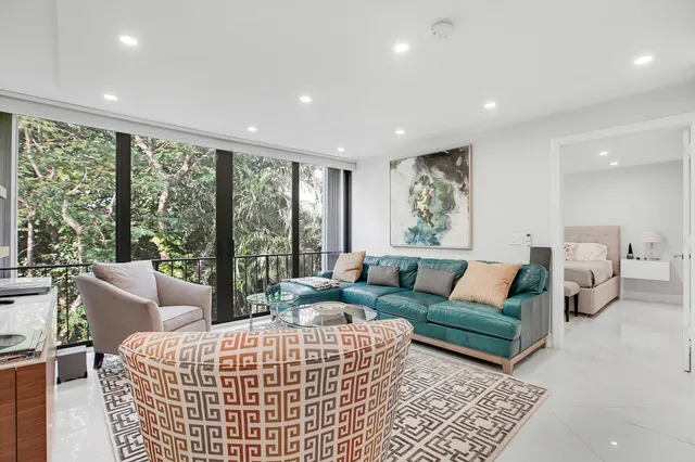 a living room with furniture and large windows