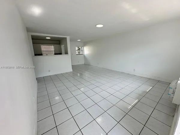 a view of a refrigerator and window in a room