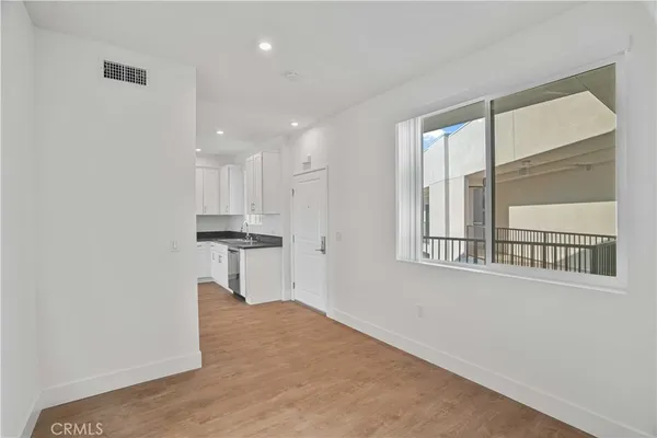 a view of a hallway with furniture and window