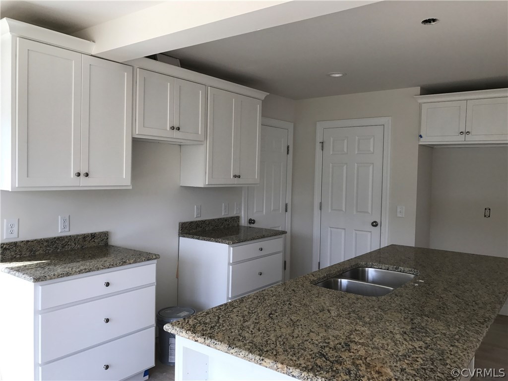 3867 Sage Road Sandy Hook, VA 23153 - Photo 3 of 6 a kitchen with white cabinets and sink