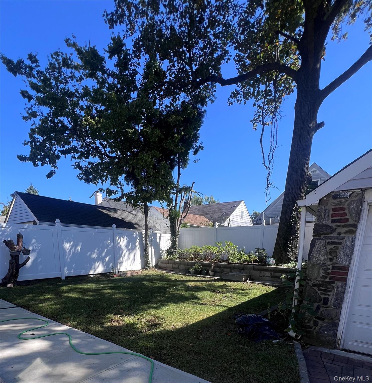 44 Frank Street Valley Stream, NY 11580 - Photo 20 of 23 a view of a yard in front of the house with a fountain