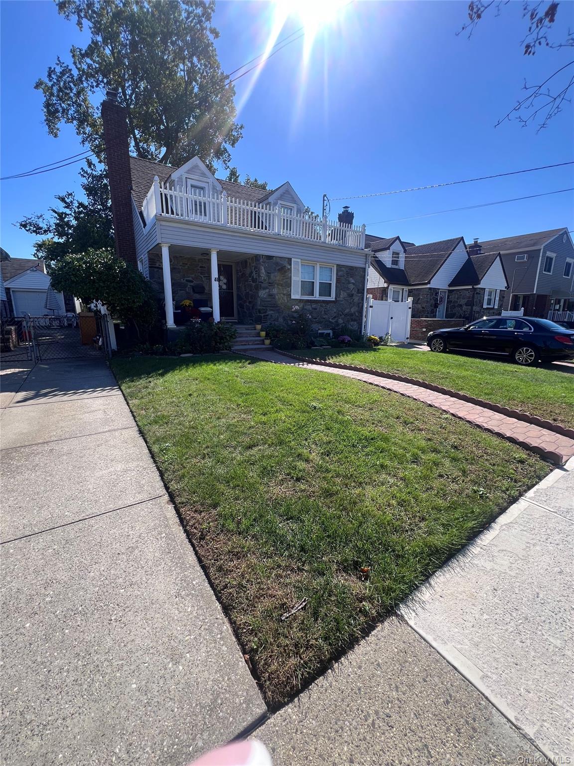 44 Frank Street Valley Stream, NY 11580 - Photo 2 of 23 a front view of a house with a garden and yard