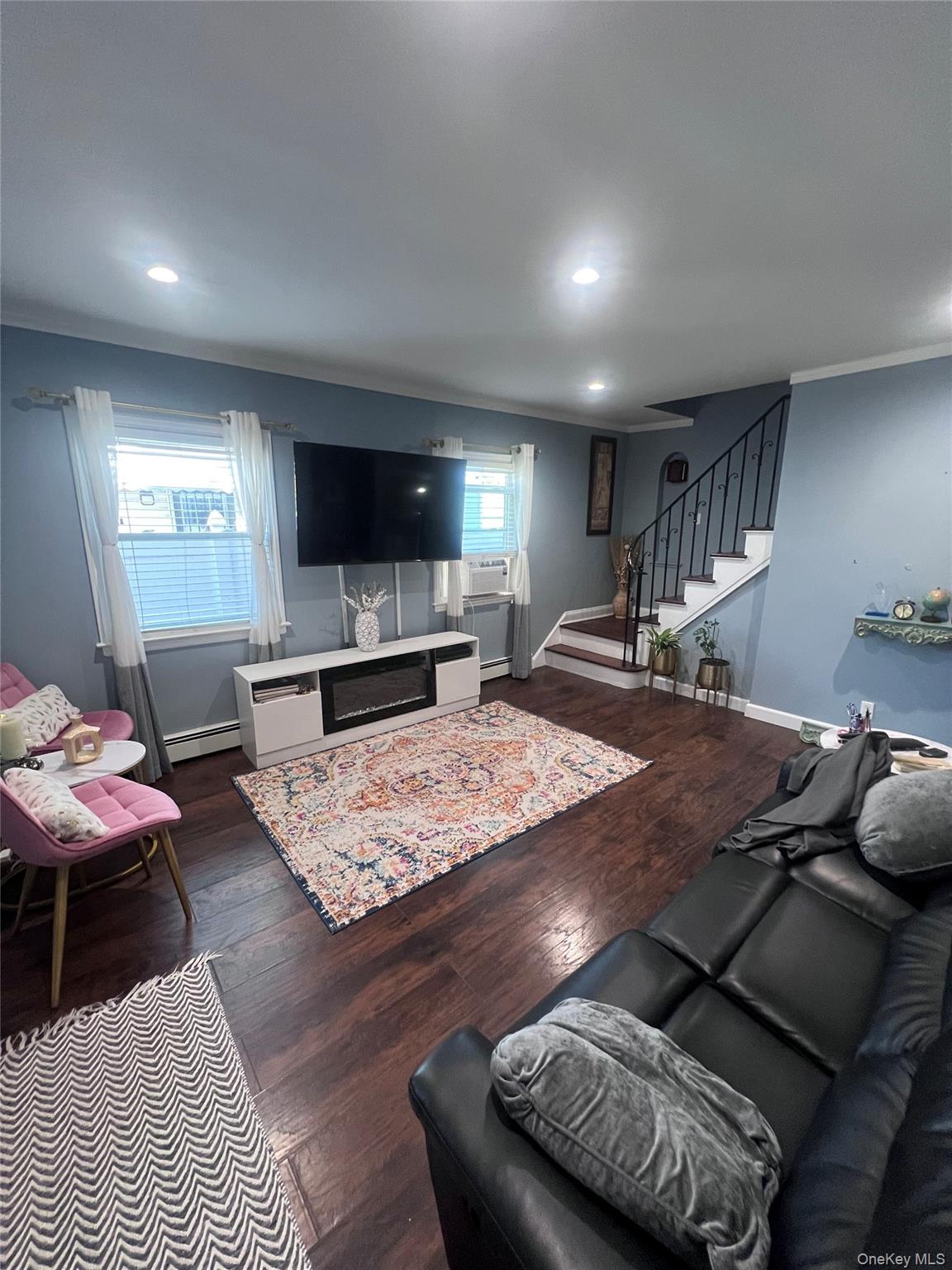 44 Frank Street Valley Stream, NY 11580 - Photo 4 of 23 a living room with furniture and a flat screen tv