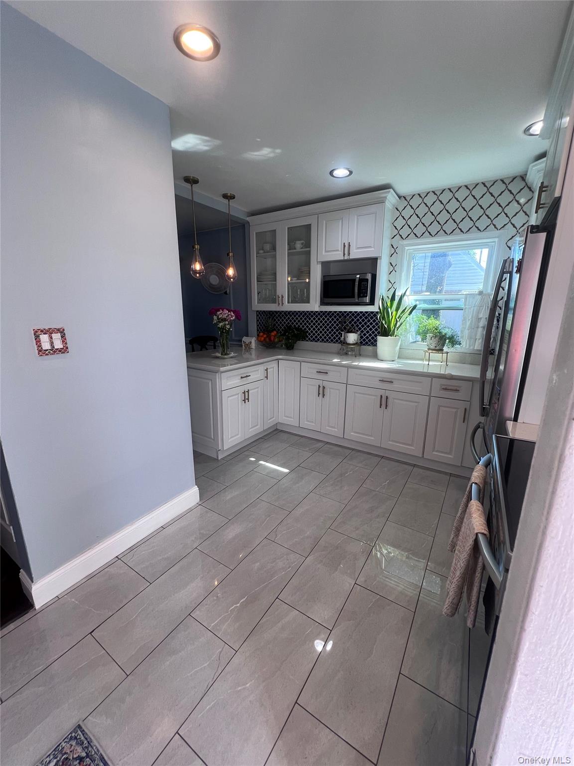 44 Frank Street Valley Stream, NY 11580 - Photo 10 of 23 a kitchen with a sink and a refrigerator in it