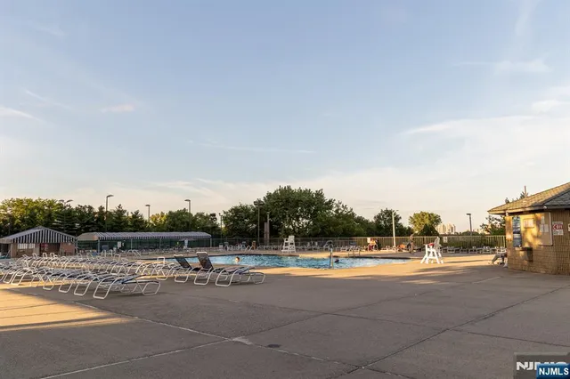 a view of patio with swimming pool and seating