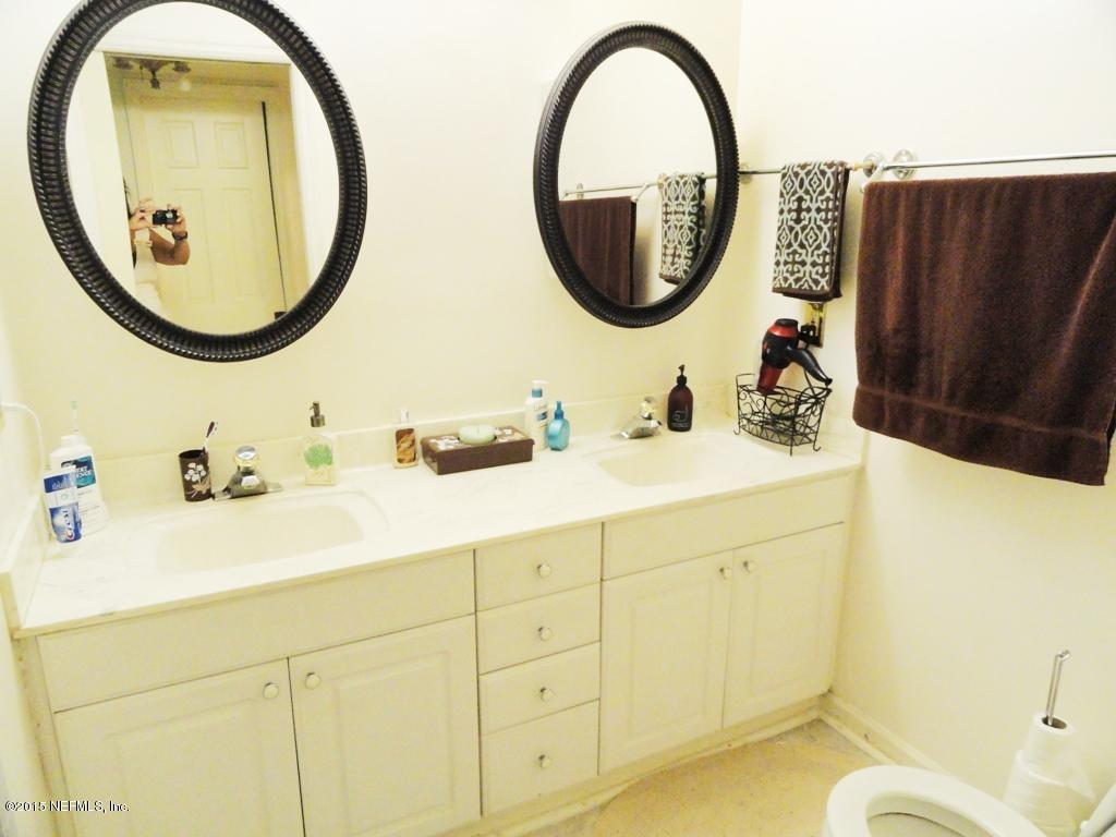 1615 Lorimier Road Jacksonville, FL 32207 - Photo 23 of 53 a bathroom with a sink a mirror and a toilet