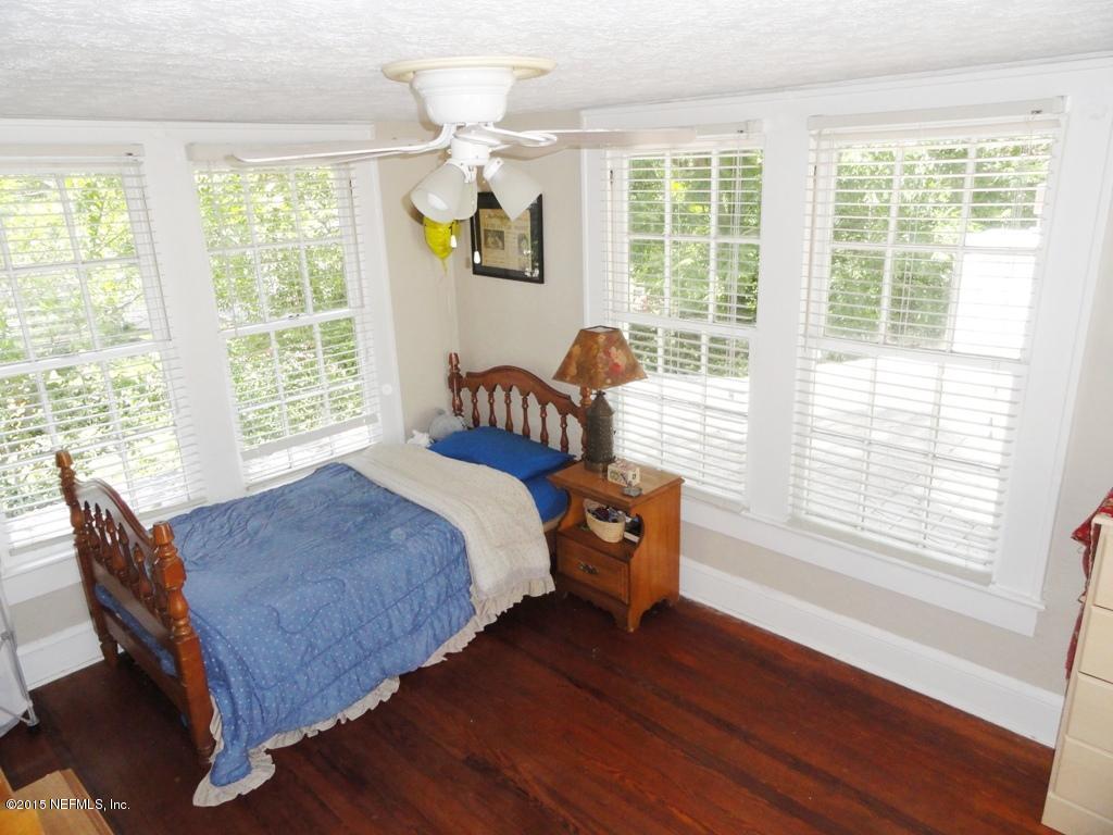 1615 Lorimier Road Jacksonville, FL 32207 - Photo 25 of 53 a bed sitting in a bedroom next to a window