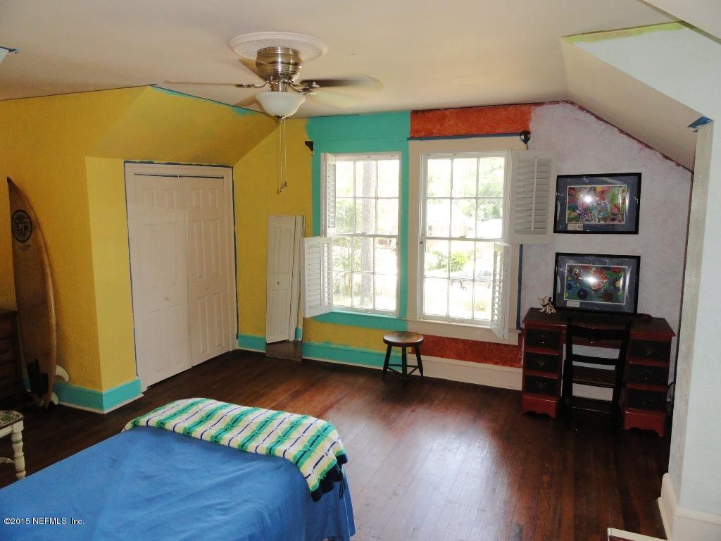 1615 Lorimier Road Jacksonville, FL 32207 - Photo 29 of 53 a bedroom with a bed and wooden floor