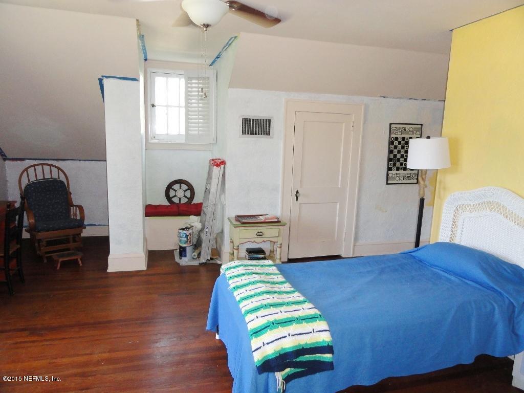 1615 Lorimier Road Jacksonville, FL 32207 - Photo 31 of 53 a bedroom with a bed and a chair in it