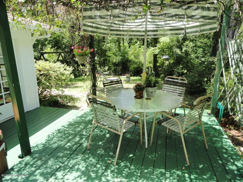 1615 Lorimier Road Jacksonville, FL 32207 - Photo 35 of 53 a backyard with table and chairs and a yard