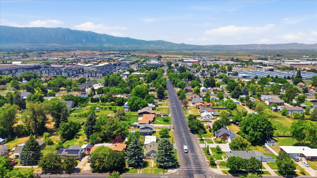 395 North 400 West Logan, UT 84321 - Photo 41 of 48 Aerial perspective showcasing a residential area with varied housing styles and mature trees