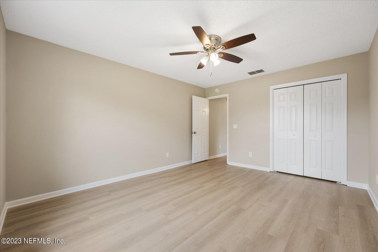 1566 Rusty Rail Road Jacksonville, FL 32225 - Photo 36 of 45 a view of a big room with wooden floor and closet area