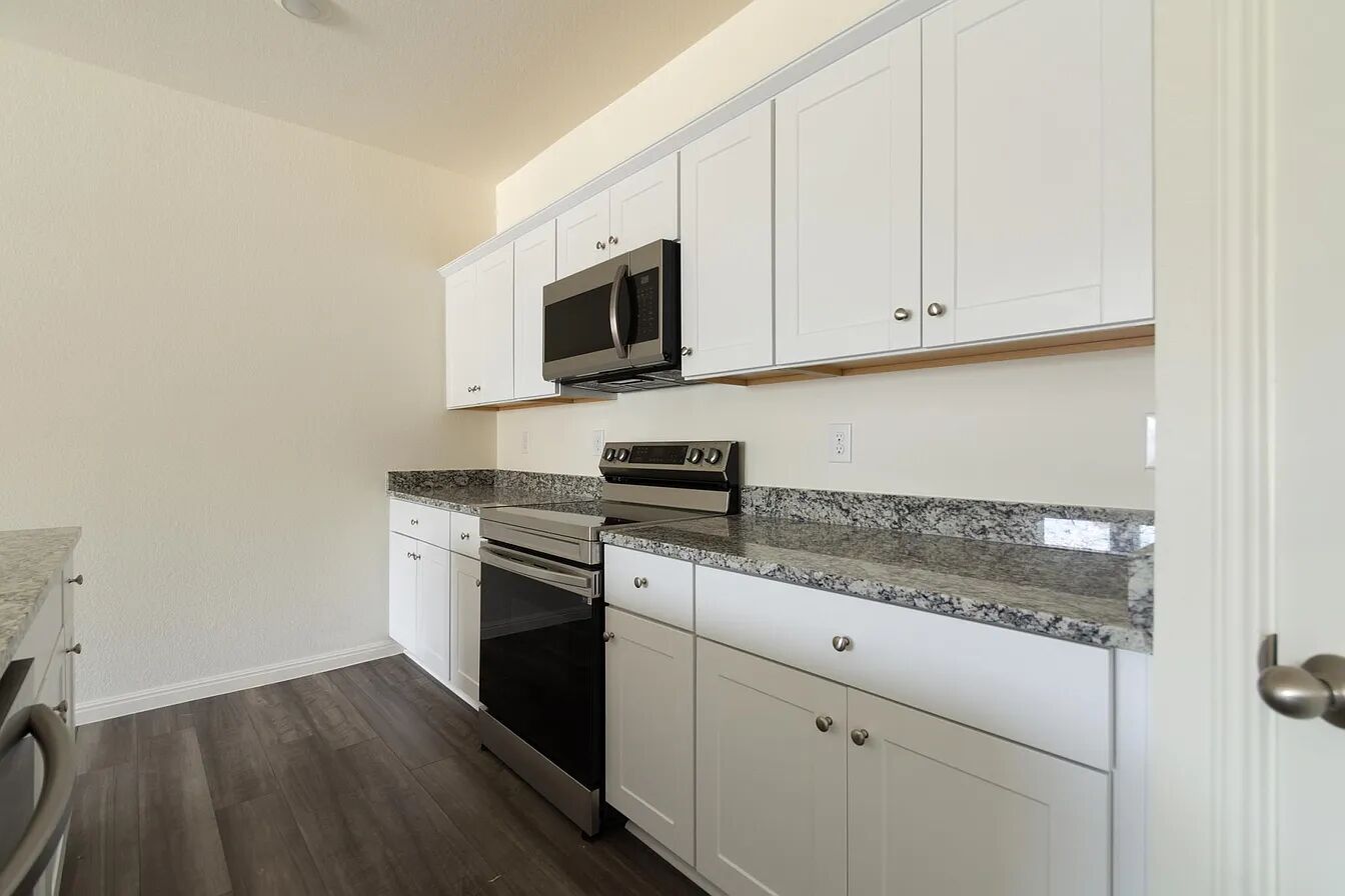 101 Aoudad Road Hutto, TX 78634 - Photo 9 of 39 A well-appointed kitchen showcasing elegant granite counters and sleek stainless steel appliances.