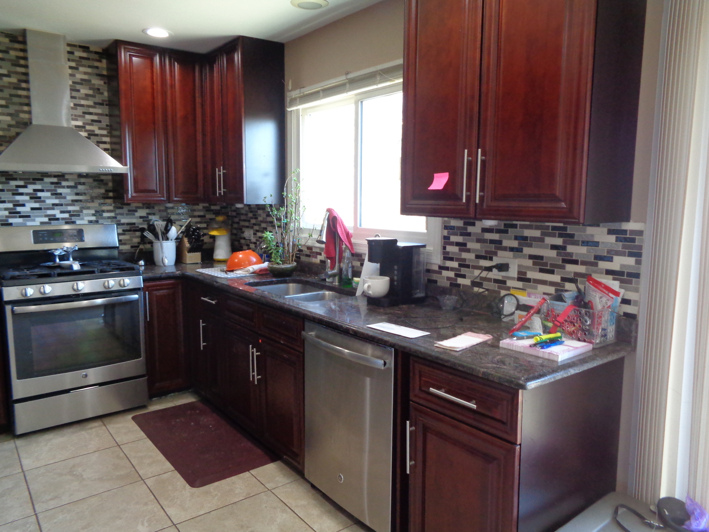 459 Barberry Road Highland Park, IL 60035 - Photo 3 of 11 a kitchen with stainless steel appliances granite countertop a sink stove and cabinets