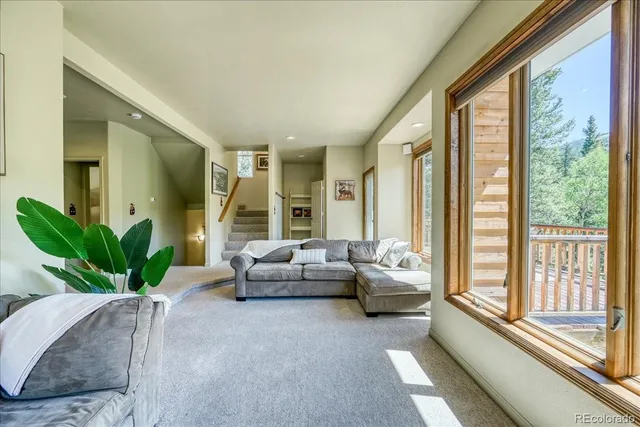 a living room with furniture and large windows