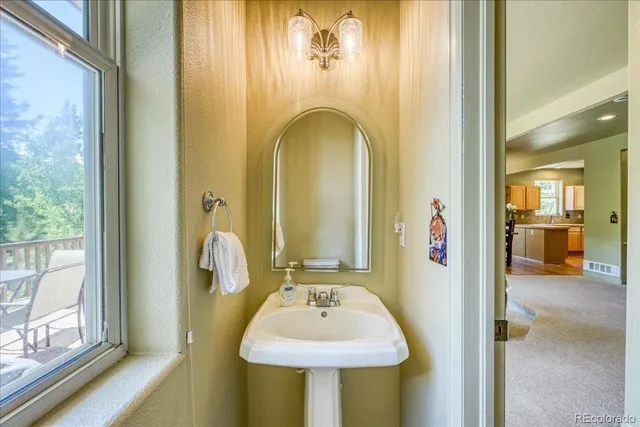 a view of a bathroom with a sink and mirror