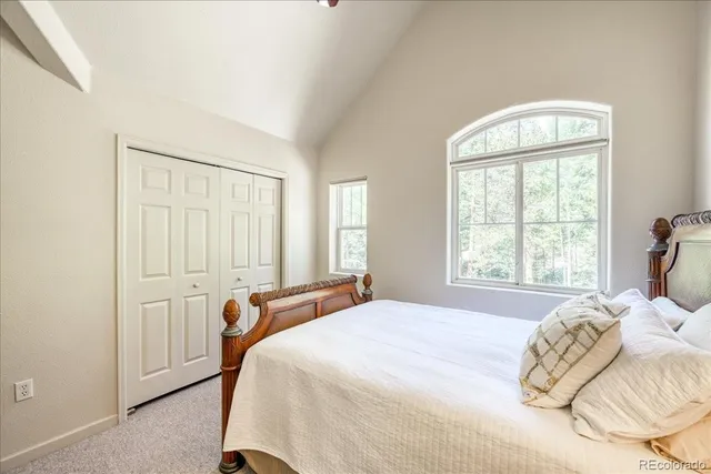 a bed sitting in a bedroom next to a window