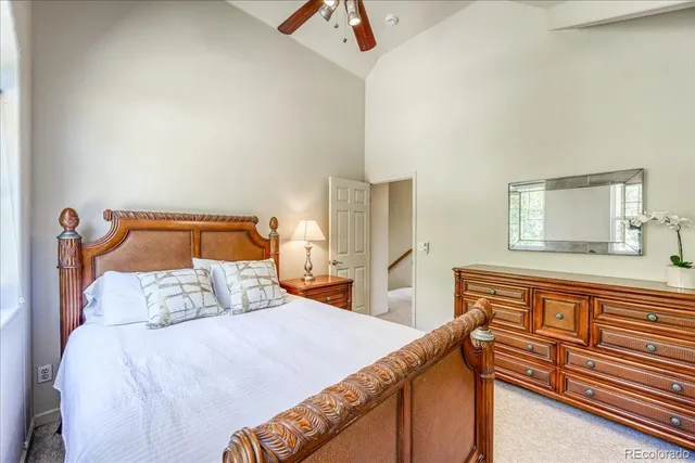 a bedroom with a bed and a dresser with the shoe rack