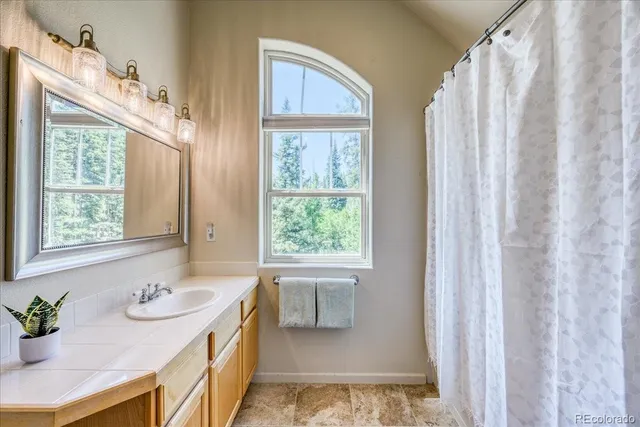 a bathroom with 2 sink tub and a window