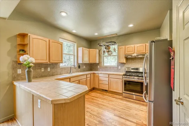 a kitchen with a sink stove and refrigerator