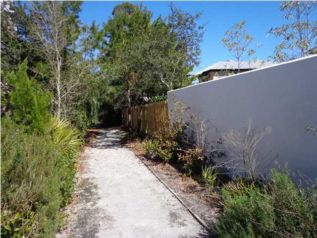 69 Lifeguard Loop East Inlet Beach, FL 32461 - Photo 26 of 26 a view of a garden with plants and a bench