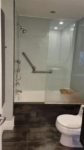 a bathroom with a toilet and a shower