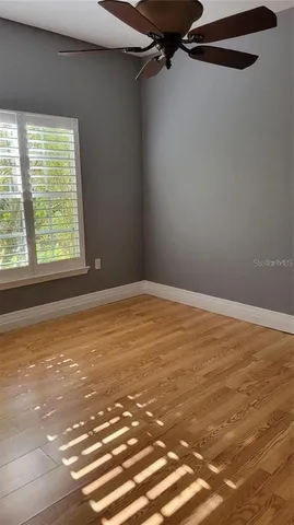 a view of a room with an empty space and a window