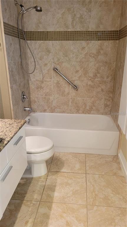 5168 Northridge Road, Unit 106 Sarasota, FL 34238 - Photo 15 of 33 a bathroom with a granite countertop bathtub shower and toilet