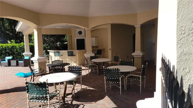 a outdoor space with furniture a rug and white walls
