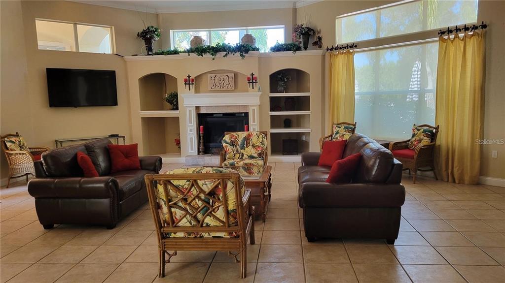5168 Northridge Road, Unit 106 Sarasota, FL 34238 - Photo 26 of 33 a living room with fireplace furniture and a flat screen tv
