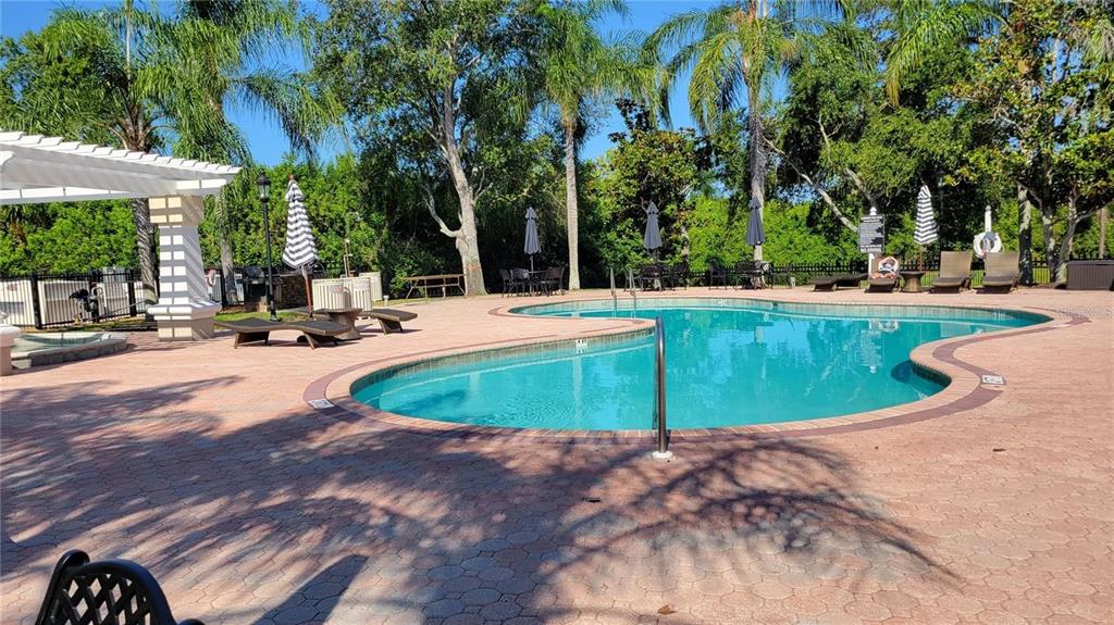 5168 Northridge Road, Unit 106 Sarasota, FL 34238 - Photo 27 of 33 a view of a swimming pool with a patio