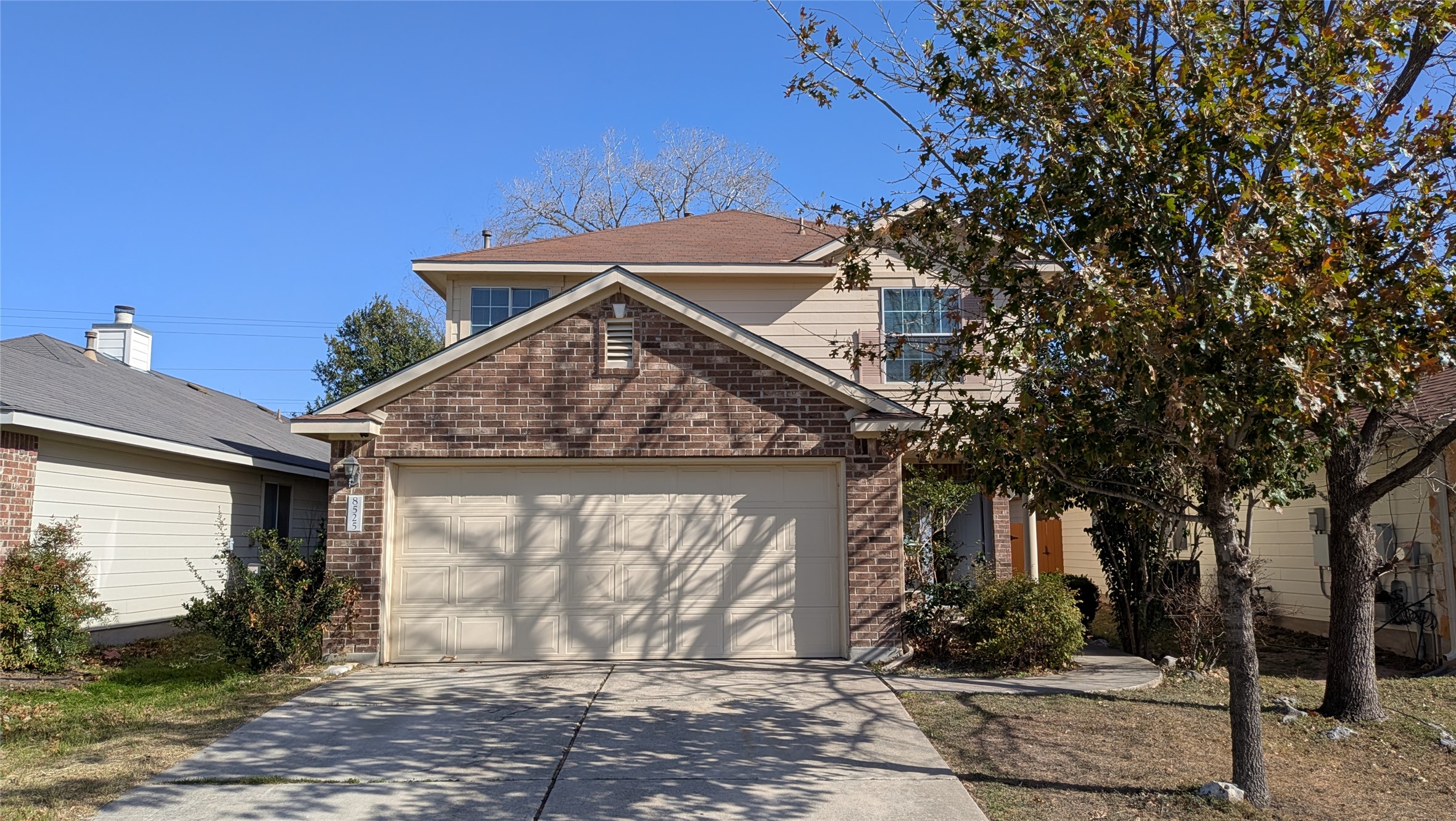 8525 Chick Pea Lane Austin, TX 78745 - Photo 1 of 22 Traditional-style house featuring brick siding, concrete driveway, and a garage