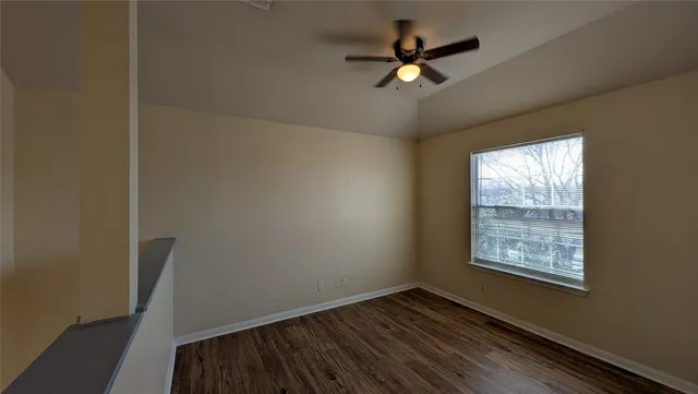 a view of hallway with stairs and wooden floor