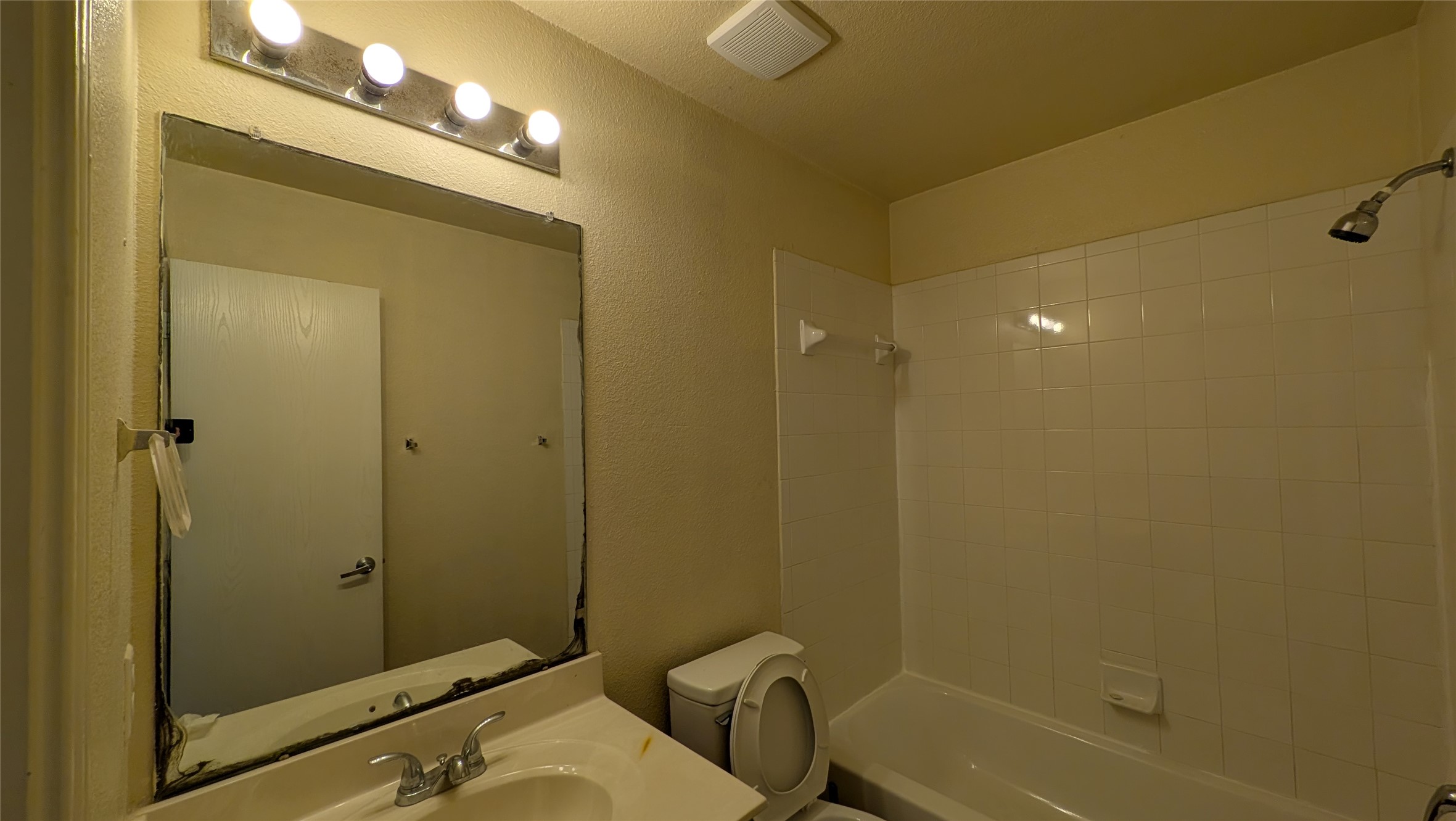 8525 Chick Pea Lane Austin, TX 78745 - Photo 11 of 22 Bathroom featuring shower / bath combination, a textured wall, and vanity