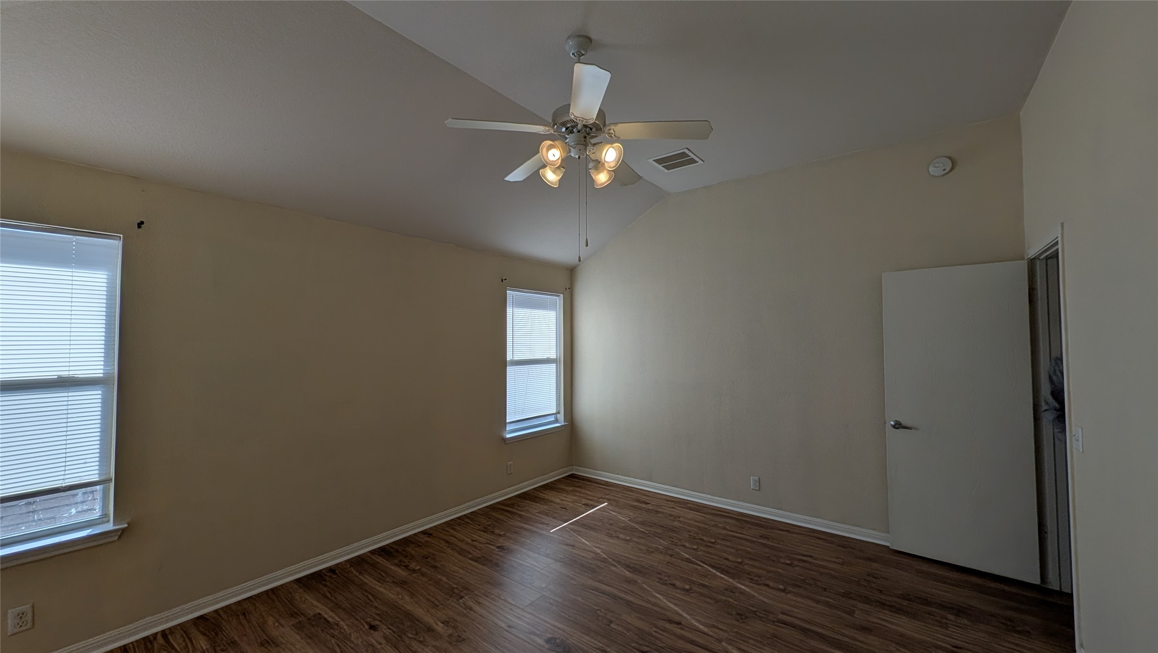 8525 Chick Pea Lane Austin, TX 78745 - Photo 14 of 22 Spare room with vaulted ceiling, dark wood-style flooring, and ceiling fan