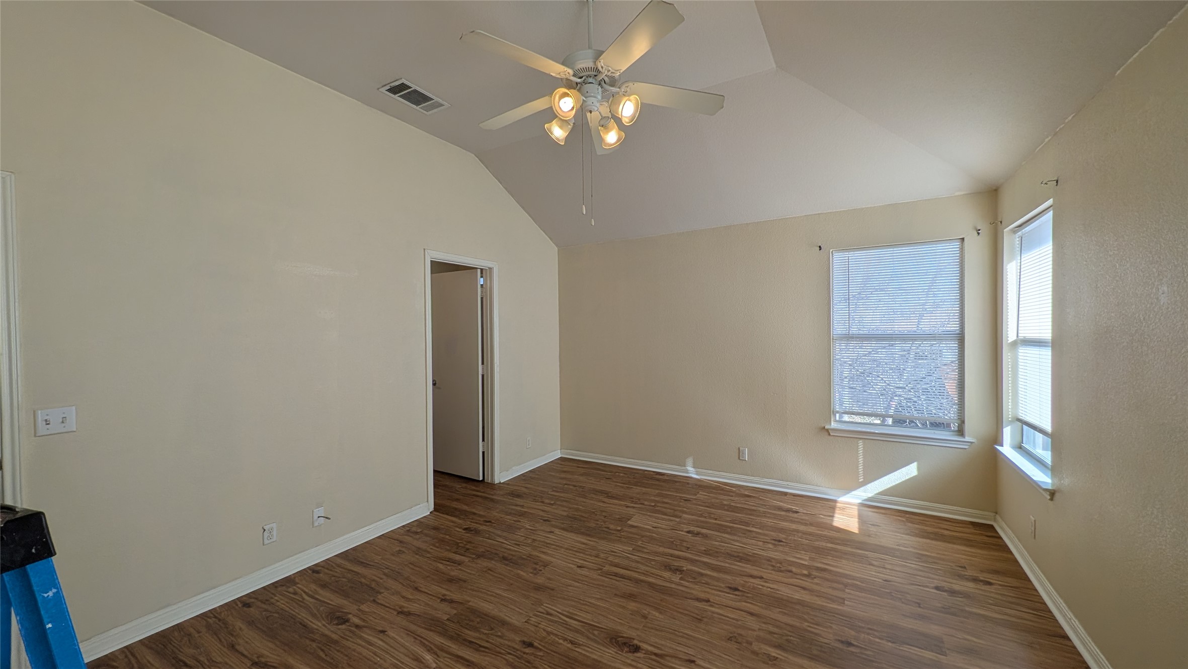 8525 Chick Pea Lane Austin, TX 78745 - Photo 15 of 22 Spare room featuring lofted ceiling, dark wood finished floors, and a ceiling fan