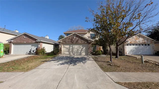 a view of a house with a tree in front of it