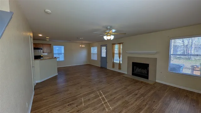 a view of an empty room with a fireplace and a window