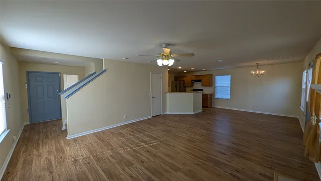 a view of a livingroom with a kitchen counter tops and wooden floor