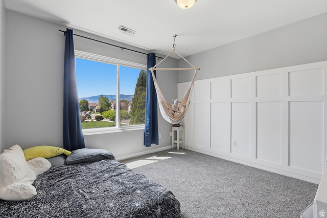 1652 West 800 South Lehi, UT 84043 - Photo 20 of 27 Bedroom with a decorative wall, a mountain view, light carpet, and a wainscoted wall